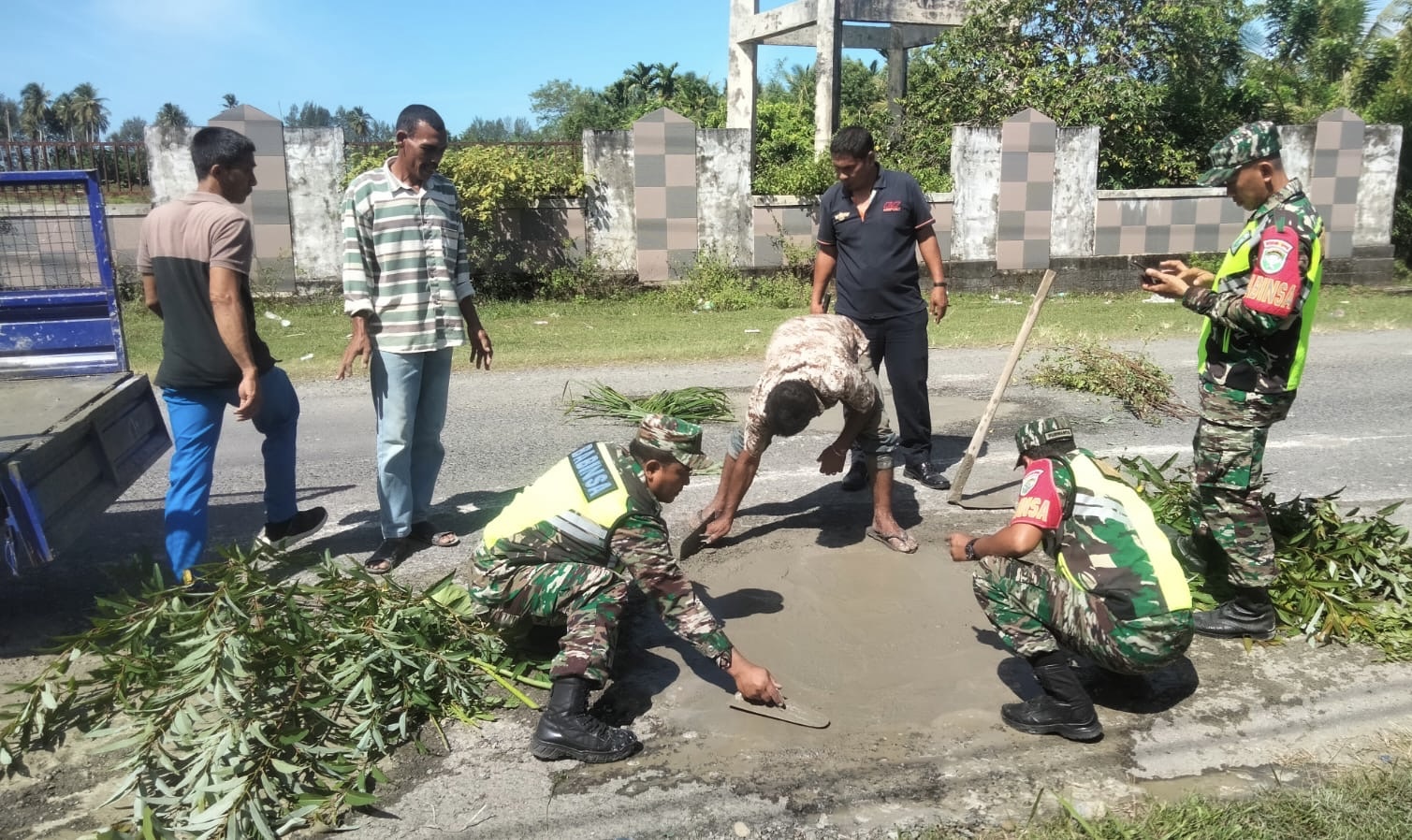Bersama Masyarakat, Personil TNI Tambal Jalan Berlubang di Nagan Raya